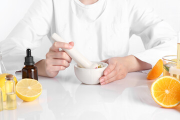 Aromatherapy product. Scientist developing essential oils at white table in laboratory, closeup