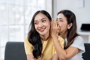 Two women are sitting on a couch