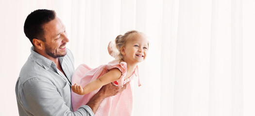 Fototapeta premium Dad Lifting Little Girl Up, Daughter Flying, Having Fun Together. Panorama, empty space.