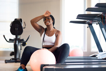 Tired and sweat. beautiful young chubby overweight african american woman wearing sporty fitness clothes doing exercise indoors at gym fitness sport club, body and health care