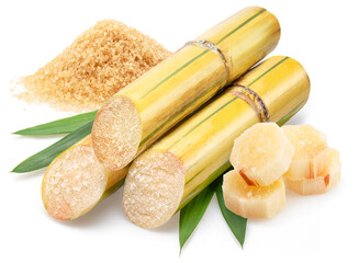 Sugarcanes stalks, sugar cane leaves and heap of sugar isolated on white background.