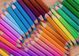 Colored pencils on a wooden table. Back to school concept. Stationery composition.