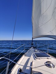 Fototapeta premium Luxury cruise on a sailing rigged yacht under a genoa and mainsail sailing in a light wind during the regatta. Yachting as a luxury sport and great vacation