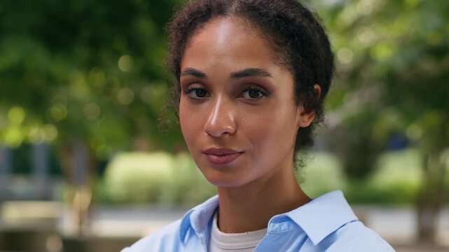 Portrait calm positive face ethnic African American student girl female business woman businesswoman lady entrepreneur manager in city urban outdoors work study education internship looking at camera