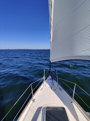 Obraz premium Luxury cruise on a sailing rigged yacht under a genoa and mainsail sailing in a light wind during the regatta. Yachting as a luxury sport and great vacation