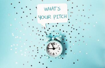 A clock with the words What's your pitch? written above it