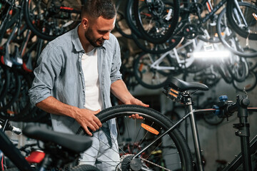 Working in the store. Repair man in bicycle shop