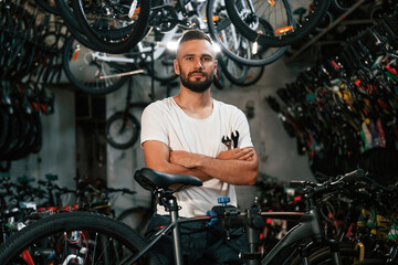 Beautiful portrait. Repair man in bicycle shop, working in store