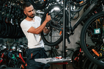 Bunch of tools. Repair man in bicycle shop, working in store