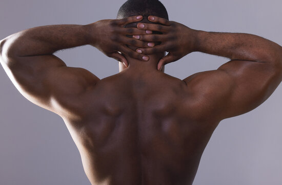 Man, back and muscle flex in studio for fitness results, body builder and strong on purple background. Male person, biceps and athlete for power of shirtless skin, exercise and topless for workout