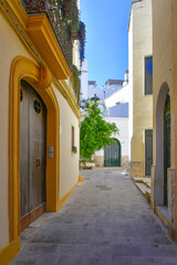 Fototapeta premium A narrow street in the historic center of Gallipoli, a tourist town in Puglia in Italy.