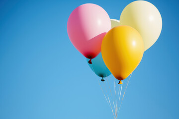 Colorful balloons floating against a clear blue sky, symbolizing joy, celebration, and freedom in a vibrant outdoor scene.