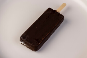 natural eco-friendly ice cream in chocolate glaze lies on a plate
