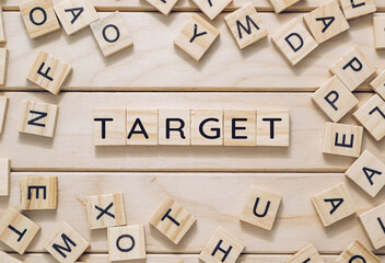 A wooden board with a bunch of wooden letters scattered around it