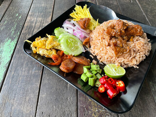 Rice Mixed with Shrimp paste  in black ceramic plate on white dish close up,thailand