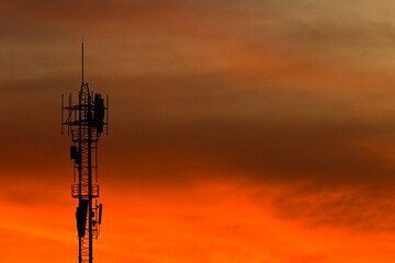 silhouette communication tower on colorful sky background