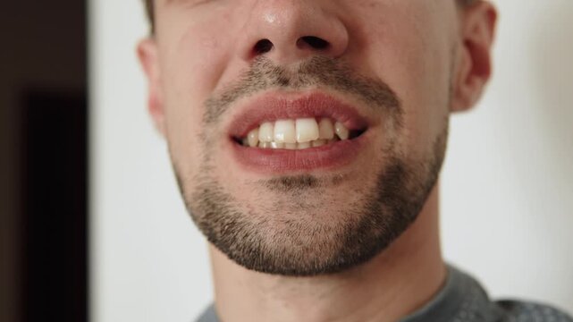 Mouth of caucasian man opening and closing close up. Gestural gymnastics with exercises and warm up for speech apparatus.