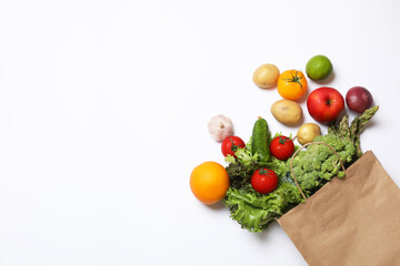 Delivery of vegetarian products. Bag with different vegetables and fruits on white background, top view