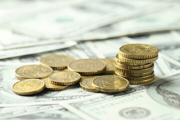 Many euro coins on dollar banknotes, closeup