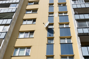 Bialystok city in Poland architecture background. High block of flats skyscraper living area. Old neighborhood retro style. Metal sheet cladding. Metal sheet facade. Polish housing market.