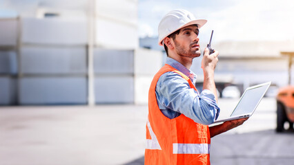 Young confident Caucasian man engineer check for control loading containers box from Cargo freight ship for import and export, transport	
