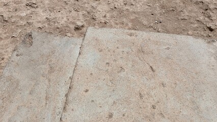 A dirty sidewalk with a white line on it
