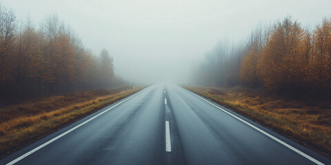 Fototapeta premium A misty and foggy empty road in the lowlands, creating a mysterious travel concept.