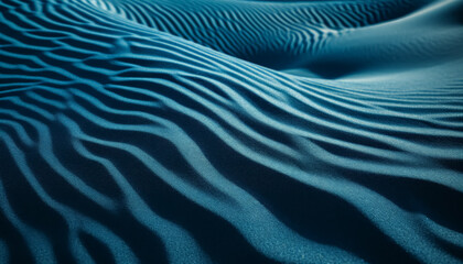 The image is of a blue ocean with a sandy beach. The water is calm and the sand is wet, creating a peaceful and serene atmosphere