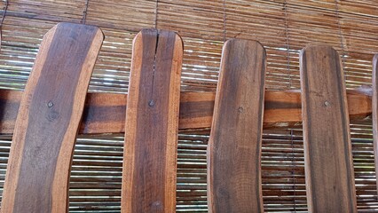 A wooden bench with four wooden slats