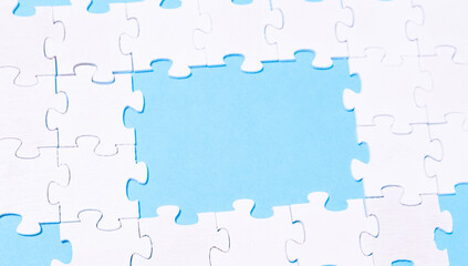 A jigsaw puzzle with a blue background and a white piece missing