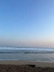The ocean is calm and the sky is blue