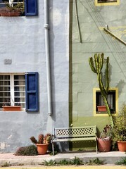 Colorful House Facade with Bench and Cactus in Gozo, Malta - Urban Street Scene