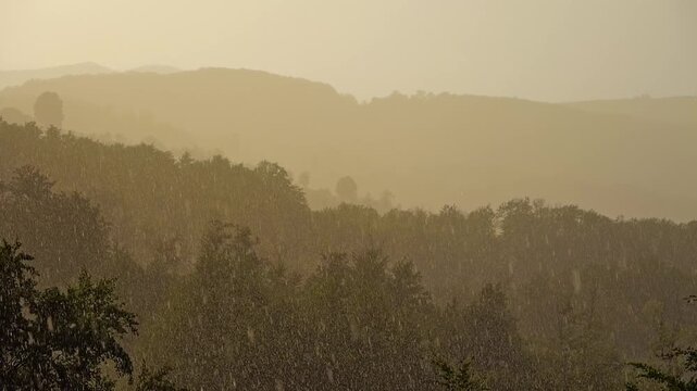 Nature landscape backlit sun shower over heels forests and mountains on sunset in slow motion.