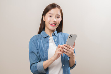 Happy asian young woman using mobile smart phone, read good news online, laugh excited getting offer, great positive surprise, celebrate success on smartphone. Smile girl isolated on white background.