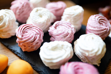 pink and white colored marshmallow cakes close up