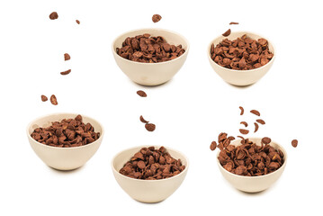 Chocolate corn flakes falling to the white bowl isolated on white. Motion.