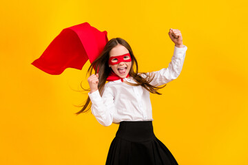 Photo of cute super girl raise fists shout yes wear uniform isolated on yellow color background