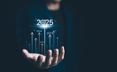 Businessman presents the year 2025 with ascending arrows representing yearly progress from 2021 to...