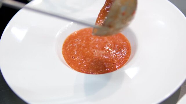Tomato gazpacho Spanish cold soup with pepper and garlic, Spanish traditional cuisine, chef cooking dinner. Delicious creamy tomato soup with herbs. Summer light yellow tomato soup. 