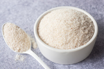 spyllium husk in white ceramic  bowl, healthy eating supplements and superfood