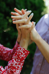 The lovers hold hands, no faces visible.