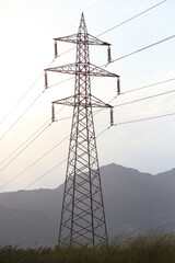 power lines with cloudy sky
