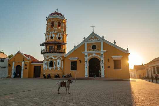 Mompos sunset over a church with a dog