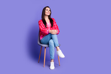 Full length photo of charming positive woman wear pink cardigan sitting stool looking empty space...