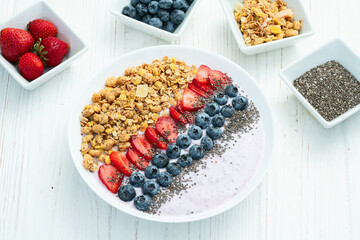 Healthy breakfast . Yogurt with berries ( strawberry , raspberry , blueberry , blackberry ) , granola and chia seeds . Top view
