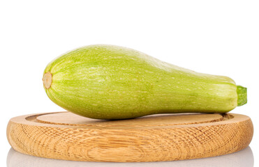One ripe zucchini on a wooden tray, macro, isolated on white background.