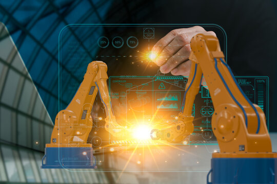 Industrial engineers employ real-time software for monitoring systems to monitor and control automation robot arms in intelligent factories using modern dashboard interfaces. digital production