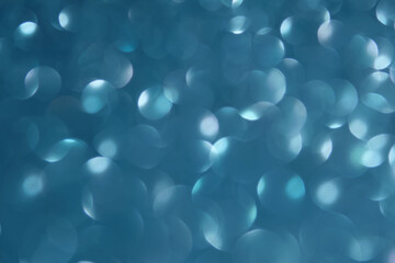 Abstract blue festive christmas background with bokeh.