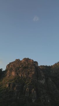 Vertical drone video. Rock formations, forested mountains and large formations. Hiking through the green forest. Hiking concept. Amatlan, Mexico
