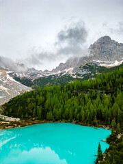 Aerial drone view of beautiful Lake Sorapis, Lago di Sorapis, in Dolomites, popular travel destination in Italy. Blue green lake in Italian Dolomites